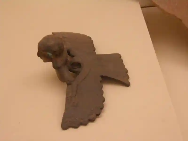 Cauldron handle in a form of a winged man with a solar disc body